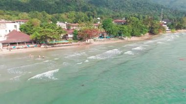 Manzaralı koh chang adası beyaz kumsal kristal berrak turkuaz sular, bereketli tropikal orman arkaplanı dinlendirici turistlerin dinlendirici sahil manzarası