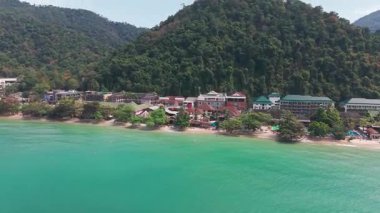 Trat, Tayland 'daki güzel koh chang adası, turkuaz sularını ve tropikal ormanlarını otellerin ve tatil beldelerinin bulunduğu sahilde gösteriyor.