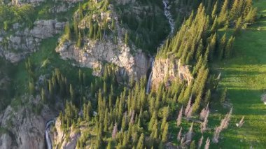 Görkemli şelale, yoğun, canlı yeşil bir ormanla çevrili sarp kayalık bir dağ yamacından aşağı doğru akar. Resmedilmeye değer bir doğal manzara yaratır.
