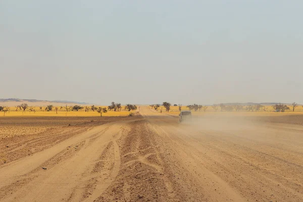 stock image Swakopmund, Namibia - 02 October 2018: Car on gravel, namibian road. Namibian wilderness.