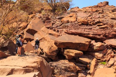 Twyfelfontein, Damaraland, Namibia - 05 October 2018: Tourists in Twyfelfontein, site of ancient rock engravings in the Kunene Region of north-western Namibia. Prehistoric Bushman engravings, rock painting.