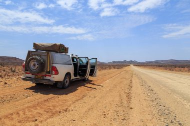 Damaraland, Namibia - 05 October 2018: Car on gravel, namibian road. Namibian wilderness.