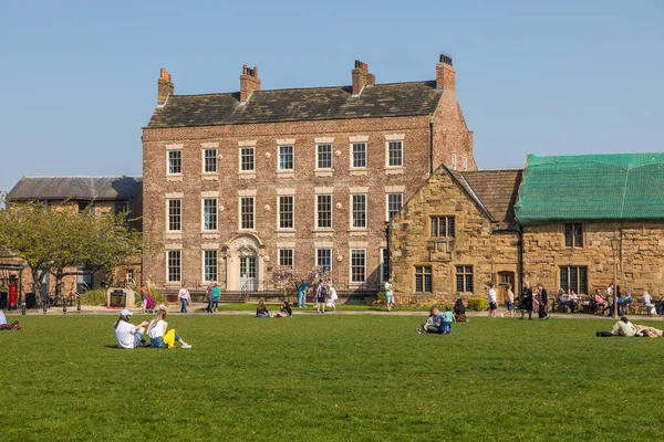 stock image Durham, North East England, UK - 22 April 2019: Students and tourists enjoying the sunshine on Palace Green.