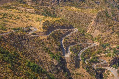 Tatew, Armenia - 03 September 2019: Landscape of the Armenian Caucasus mountains. Winding mountain road. clipart