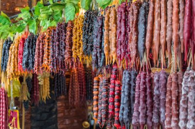 Churchkhela. Traditional Georgian sausage-shaped candy with grape must, nuts and flour. eastern sweets, street food. tbilisi, Georgia. clipart