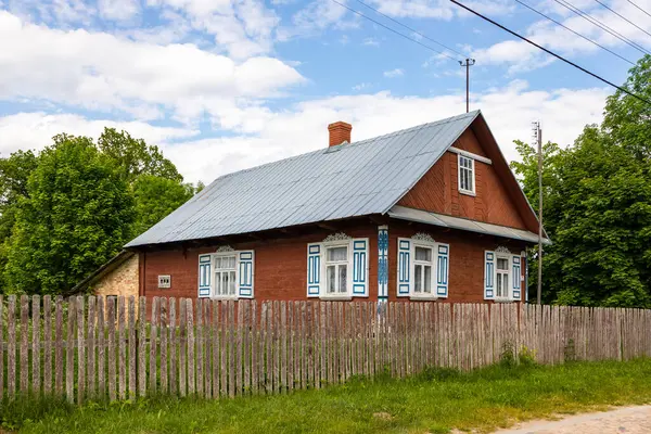 Soce, Podlasie bölgesinde, Polonya 'da mavi ve beyaz panjurları ve teneke çatısı olan büyüleyici ahşap bir kır evi..