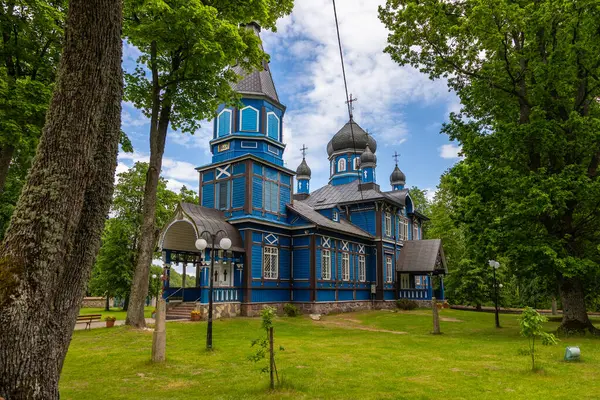 Puchly, Polonya - 4 Haziran 2021: Ağaçlarla çevrili mavi ahşap Ortodoks Kilisesi.