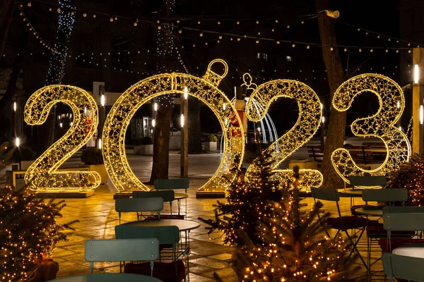 New Year decorations with big numbers 2023. Festive illumination, Christmas celebration concept. New year 2023, image for greeting card. New year celebration, golden lights.