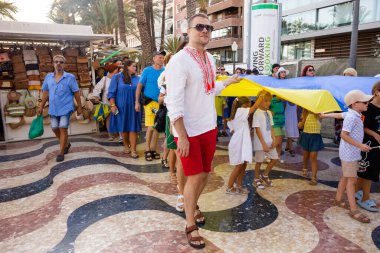 ALICANTE, İSPAN - 24 AĞUSTOS 2023 Ukraynalılar Mart 'ta dev mavi-sarı bayrağıyla ulusal giyindiler. Ukrayna 'nın Bağımsızlık Günü' nü kutluyoruz..