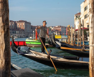 October 31, 2022 - Venice, Italy: Gondolier standing in a gondola. Tourism concept.