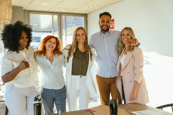 Diverse business team smiling while standing together in the office. Business concept.