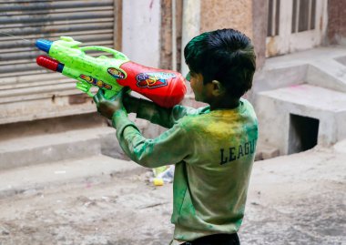 March 20222, Hisar, Haryana : Indian children celebrating Holi with colors and pichkari during Holi festival
