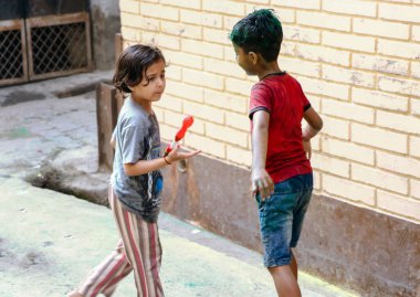 March 20222, Hisar, Haryana : Indian children celebrating Holi with colors and pichkari during Holi festival