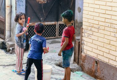 March 20222, Hisar, Haryana : Indian children celebrating Holi with colors and pichkari during Holi festival