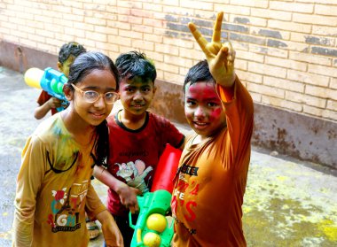 March 20222, Hisar, Haryana : Indian children celebrating Holi with colors and pichkari during Holi festival