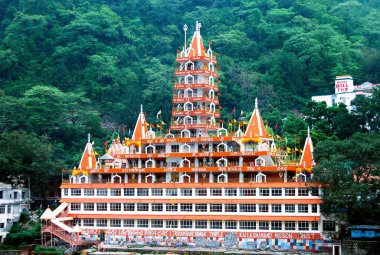 Rishikesh, Hindistan, 22 Haziran 2024: Muhteşem Trayambakeshwar Tapınağı, 13 katlı bir mimari mucize, Uttarakhand, Uttarakhand, Hindistan 'daki Ganj Nehri kıyısında zarif bir şekilde duruyor.