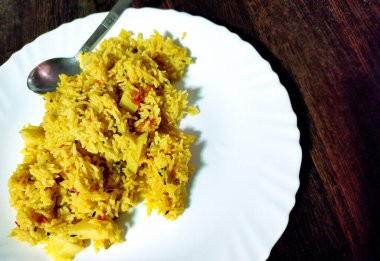 Basmati pilavı, bezelye, patates, domates ve hafif baharatlarla yapılmış taze pişmiş Hint sebze pulaosunun yakın çekimi.