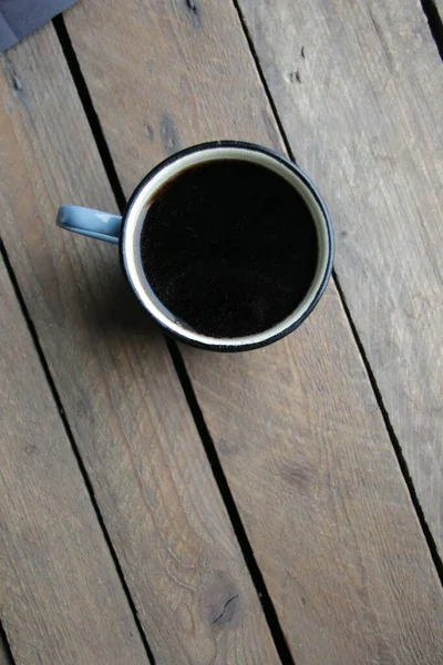 Mug of coffee on a old wooden table.