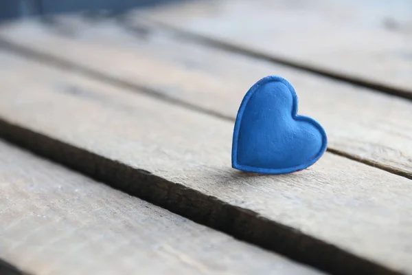 Blue heart on a wooden background. Place for text. Valentines card. Birthday background.