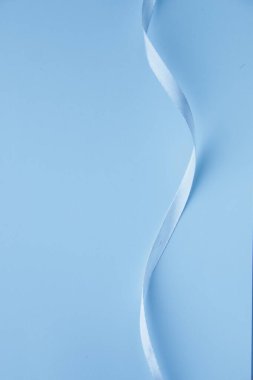 Blue background. Blue ribbon on a blue background. Background for a card.