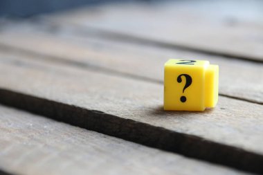 Question mark on a yellow cube. Place for text. Vintage style.