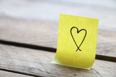 Heart on a paper tag. Birthday background. Valentine's Day concept.