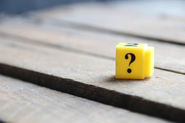 Question mark on a yellow cube. Place for text. Vintage style.