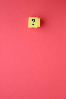 Large question mark on a red background.