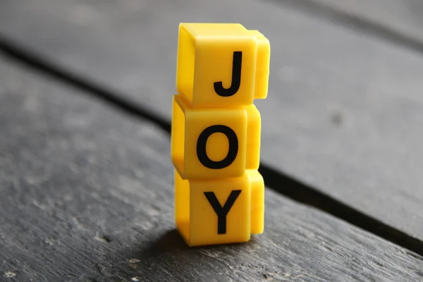 Joy Creative Concept Inscription Yellow Cubes Stockbild