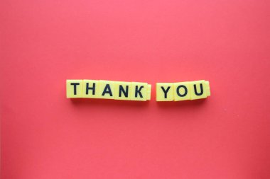 Thank you concept inscription in yellow letters on a red background. clipart