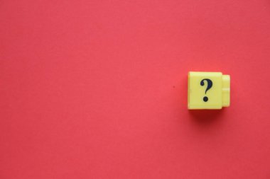 Large question mark on a red background.