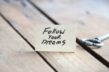 Motivational quotes. Follow your dreams text written on a tag. Vintage style.
