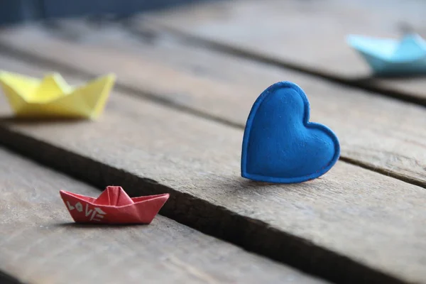Blue heart on a wooden background. Place for text. Summer time.