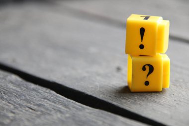 Question mark and exclamation mark concept, inscription on yellow cubes.