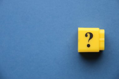 Large question mark on a blue background..