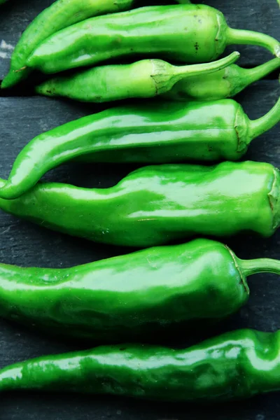 Stock image Fresh ripe green peppers on vintage table.