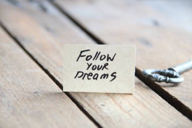 Motivational quotes. Follow your dreams text written on a tag. Vintage style.
