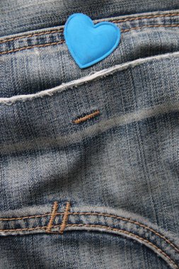 Blue heart on jeans. Creative Birthday background.