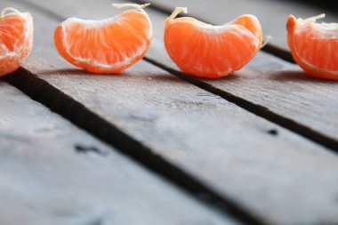 Slice of tangerine on old vintage table.
