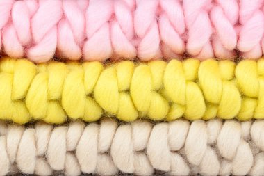 Close-Up of Chunky Knit Wool Blankets in Soft Pink, Beige, and Yellow  Cozy Handcrafted Textures for Home Decor, Knitting Projects, and Warm Interior Design Ideas clipart