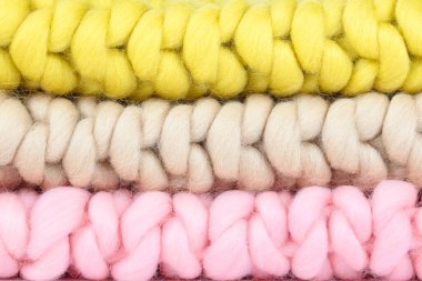 Close-Up of Chunky Knit Wool Blankets in Soft Pink, Beige, and Yellow  Cozy Handcrafted Textures for Home Decor, Knitting Projects, and Warm Interior Design Ideas clipart