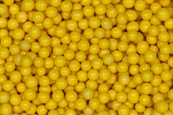 Canlı Sarı Şeker Fışkıran Arkaplan: Pasta Dekorasyonu ve Şekerleme Garnitürleri İçin Kullanılan Dekoratif Şeker İncilerinin Makro Fotoğrafı