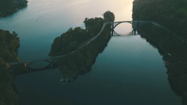 Akşamları nehrin üzerindeki köprünün hava görüntüsü. Skodje Köprüsü (Norveççe: Skodje bru). Norveç 'in Alesund şehrinde Skodjestraumen' i geçen eski köprü..