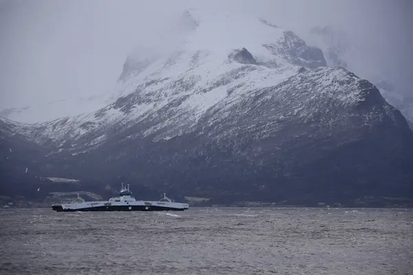 Eidsnes, Norveç - 2 Şubat 2024: Ingunn fırtınası sırasında dağlar arasında bir feribot hareket eder