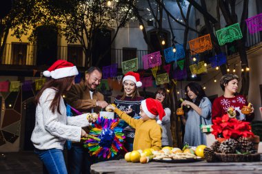 Mexican Posada, Hispanic family Singing carols in Christmas celebration in Mexico Latin America clipart