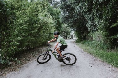 hispanic Senior man on his mountain bike cycling outdoors in Mexico Latin America 