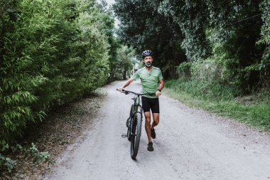 hispanic Senior man on his mountain bike cycling outdoors in Mexico Latin America 