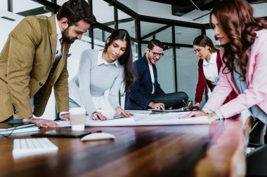 Group of young hispanic people of architects or Designer teamwork planning and working on interior design project or architecture development in a creative office in Mexico Latin America