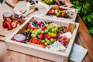 Appetizers table with brie cheese, fruit and snacks. Cheese and meat variety board in Mexico Latin America