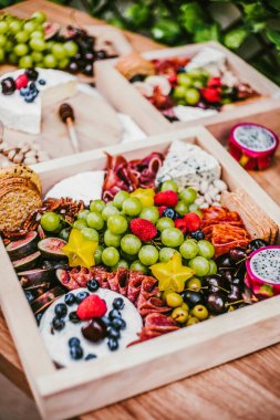 Appetizers table with brie cheese, fruit and snacks. Cheese and meat variety board in Mexico Latin America
